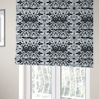 The fabric used to create these Roman blinds is a spooky, ornate damask-style repeating pattern on a white background featuring black skulls, bats, spiderwebs with small spiders, and crossbones.