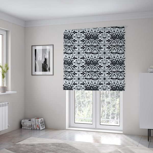 The fabric used to create these Roman blinds is a spooky, ornate damask-style repeating pattern on a white background featuring black skulls, bats, spiderwebs with small spiders, and crossbones.