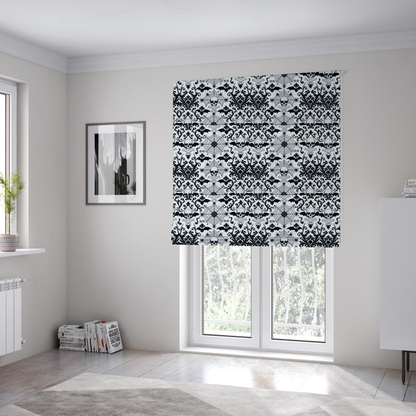 The fabric used to create these Roman blinds is a spooky, ornate damask-style repeating pattern on a white background featuring black skulls, bats, spiderwebs with small spiders, and crossbones.