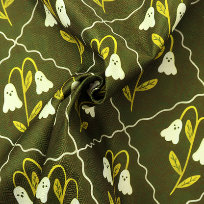 A dark olive-green vintage-style pattern featuring an ogee trellis grid framing whimsical, ghost-like floral blossoms with tiny faces.
