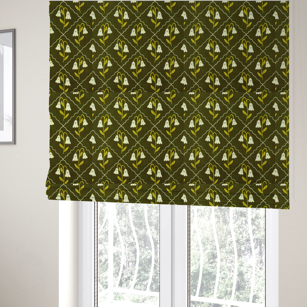 The fabric used to create these Roman blinds is a dark olive-green vintage-style pattern featuring an ogee trellis grid framing whimsical, ghost-like floral blossoms with tiny faces.