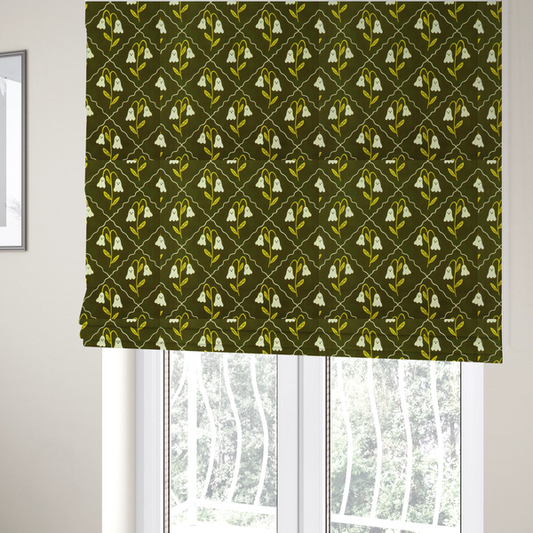 The fabric used to create these Roman blinds is a dark olive-green vintage-style pattern featuring an ogee trellis grid framing whimsical, ghost-like floral blossoms with tiny faces.