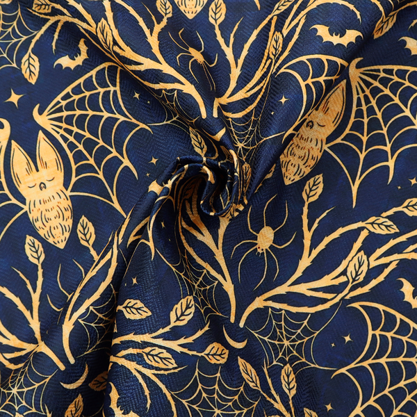 A dark navy blue gothic damask pattern featuring golden yellow bats with webbed wings, intricate spiderwebs, spiders, and twisting branches with leaves.