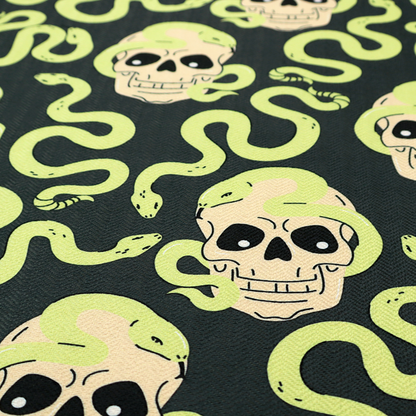 A dark charcoal pattern featuring glowing light green snakes slithering around and coiling through off-white human skulls.