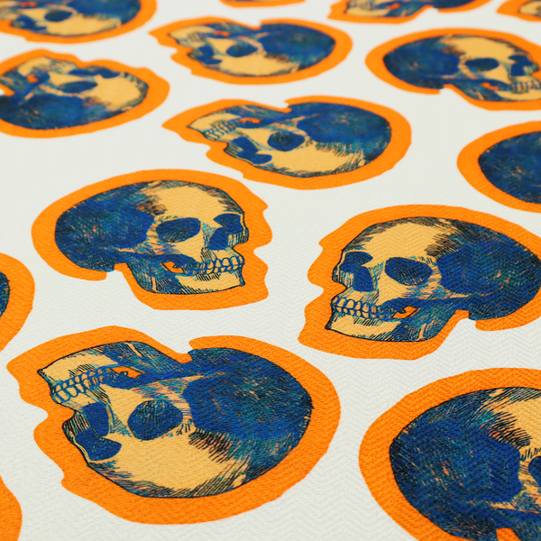A repeating pattern on an off-white background featuring distressed blue and yellow human skulls outlined in bright orange.