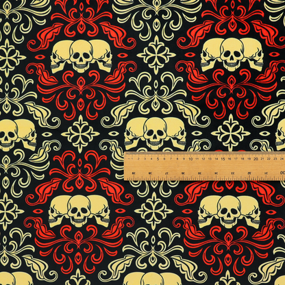 A black gothic damask pattern featuring ornate red and cream scrolling foliage, fleur-de-lis accents, and groups of three yellow human skulls.