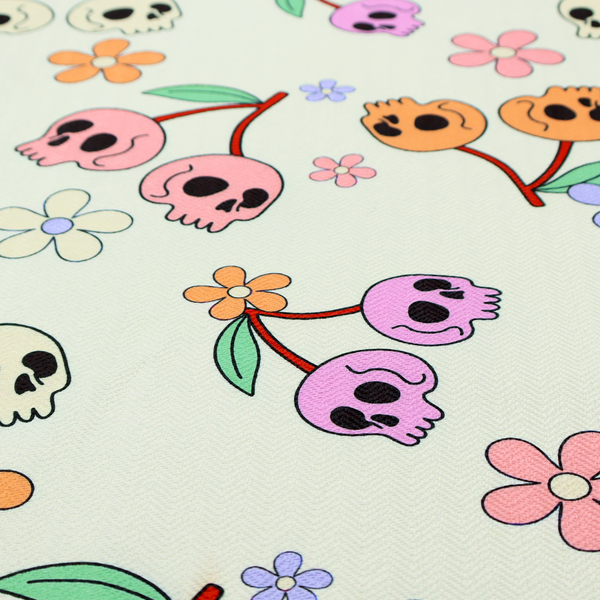 A light retro-style pattern featuring whimsical cherry pairs where the fruit is shaped like colourful skulls in shades of cream, pink, orange, and purple, accented by simple pastel flowers.