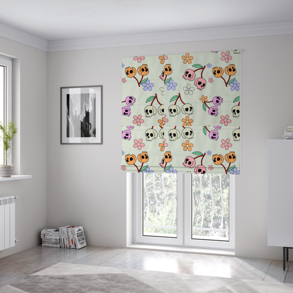 The fabric used to create these Roman blinds is a light retro-style pattern featuring whimsical cherry pairs where the fruit is shaped like colourful skulls in shades of cream, pink, orange, and purple, accented by simple pastel flowers.