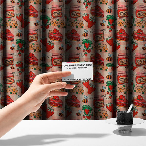 The fabric used to create these made-to-measure curtains is a charming, whimsical repeating pattern featuring strawberry-themed motifs—including jars labelled "Strawberry Jam," slices of cake topped with strawberries, fresh strawberries on the vine, orange flowers, and buzzing bees—set against a pink and white gingham background.