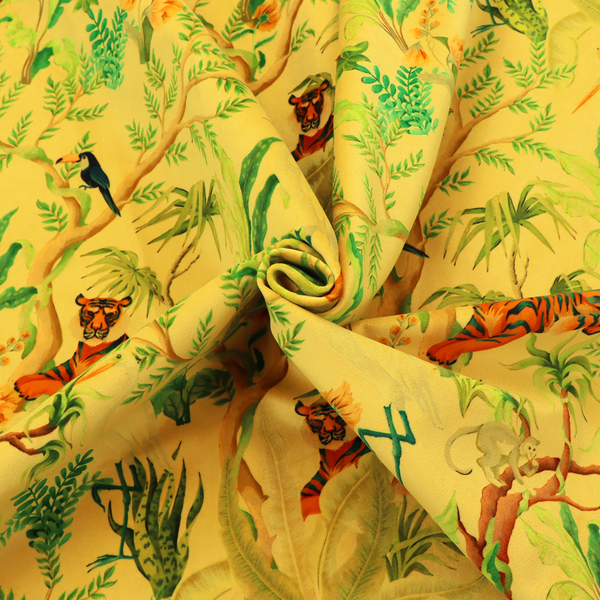 A vibrant yellow fabric featuring a dense tropical jungle pattern with tigers lounging on branches, toucans, herons, monkeys, and lush green foliage.   