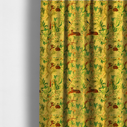 The fabric used to create these made-to-measure curtains is a vibrant yellow fabric featuring a dense tropical jungle pattern with tigers lounging on branches, toucans, herons, monkeys, and lush green foliage.   