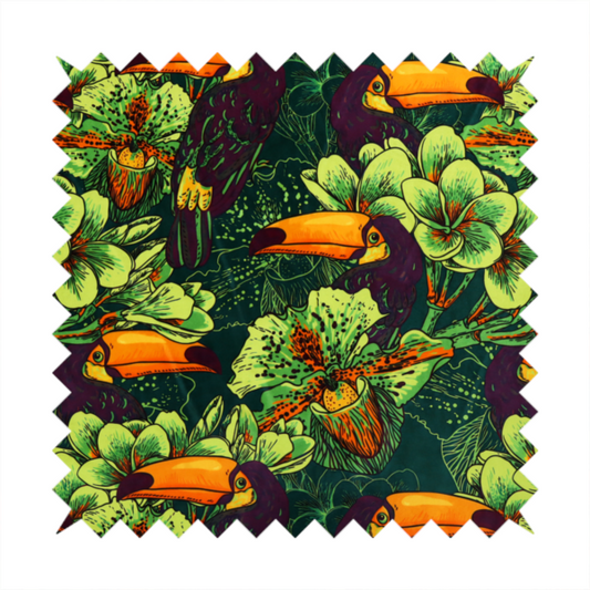 A dark green fabric densely patterned with toucans featuring large orange-and-yellow beaks, surrounded by glowing light green and orange tropical flowers.   