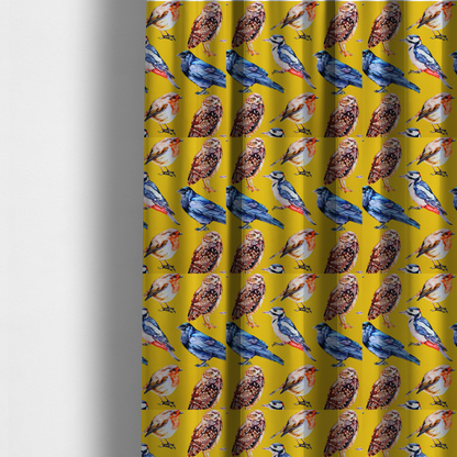 The fabric used to create these made-to-measure curtains is a vibrant yellow fabric patterned with a repeat design of various illustrated birds, including owls, robins, woodpeckers, and bluebirds