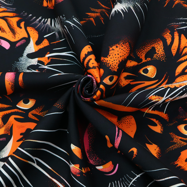 A dark patterned fabric featuring an aggressive, repeated motif of roaring tigers with bared fangs, detailed in vibrant orange, white, and pink against a black background.   