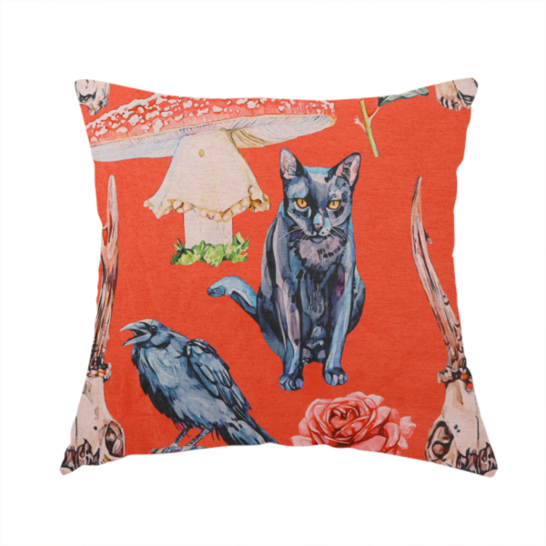 The fabric used to create this handmade cushion is a red fabric patterned with hand-drawn gothic illustrations of black cats, crows, animal skulls, mushrooms, and roses featuring an organic style.