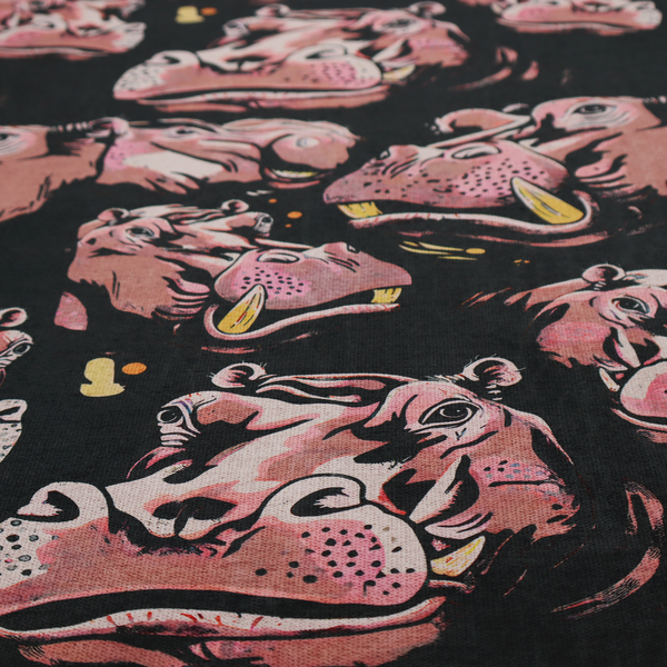 A dark grey fabric patterned with hand-drawn illustrations of hippos featuring an organic style.