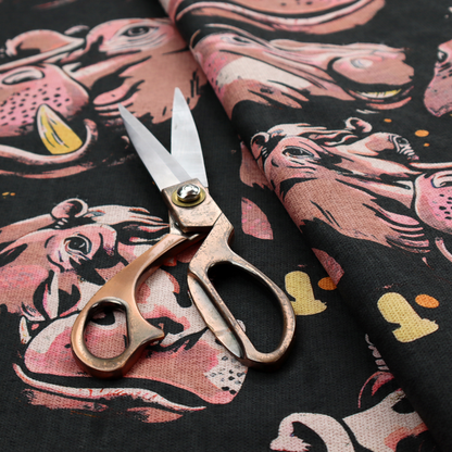 A dark grey fabric patterned with hand-drawn illustrations of hippos featuring an organic style.