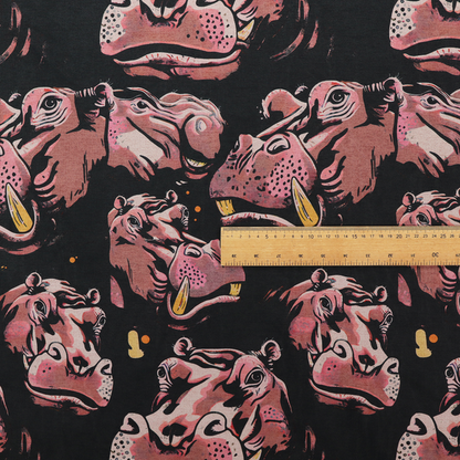A dark grey fabric patterned with hand-drawn illustrations of hippos featuring an organic style.