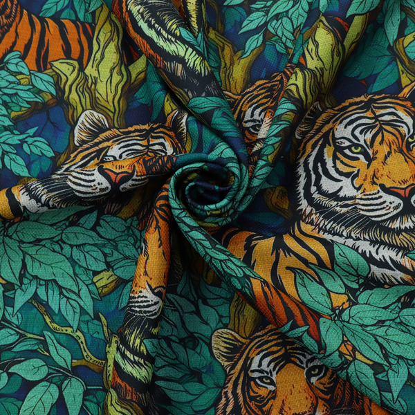 A dark blue fabric patterned with hand-drawn jungle illustrations of tigers nestled among dense green leaves featuring an organic style.