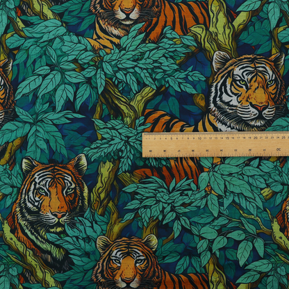 A dark blue fabric patterned with hand-drawn jungle illustrations of tigers nestled among dense green leaves featuring an organic style.