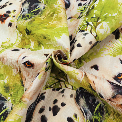 A green and white fabric patterned with hand-drawn illustrations of Dalmatians nestled among lush foliage featuring an organic style.