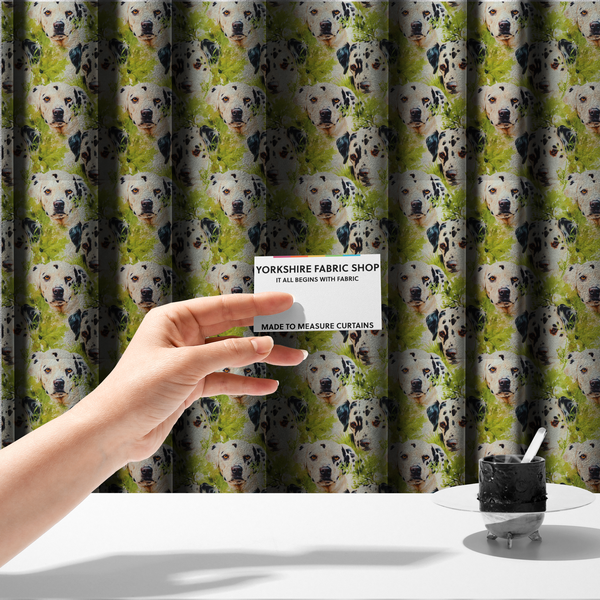 The fabric used to create these made-to-measure curtains is a green and white fabric patterned with hand-drawn illustrations of Dalmatians nestled among lush foliage featuring an organic style.