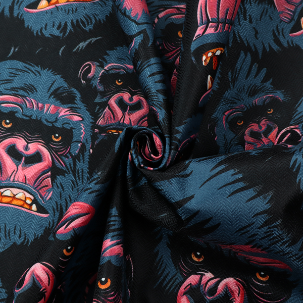 A dark blue fabric patterned with hand-drawn illustrations of gorillas featuring an organic style.   