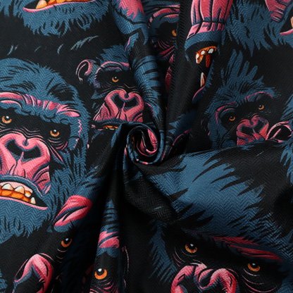 A dark blue fabric patterned with hand-drawn illustrations of gorillas featuring an organic style.   
