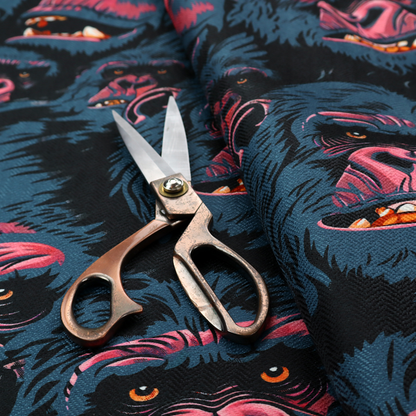A dark blue fabric patterned with hand-drawn illustrations of gorillas featuring an organic style.   