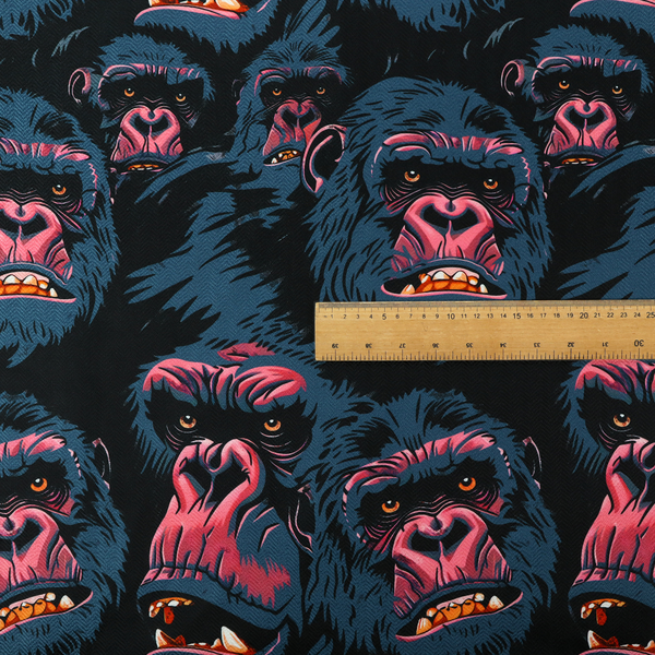 A dark blue fabric patterned with hand-drawn illustrations of gorillas featuring an organic style.   