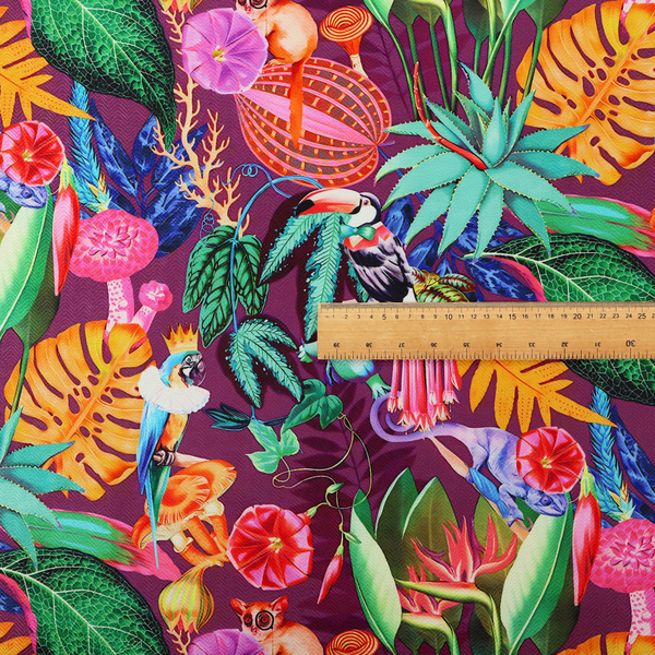 A burgundy fabric patterned with hand-drawn jungle illustrations of toucans, tarsiers, colourful birds, and tropical foliage featuring an organic style.   
