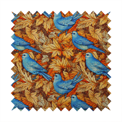 An orange and brown fabric patterned with hand-drawn botanical illustrations of blue birds perched amongst fall leaves featuring an organic style.   
