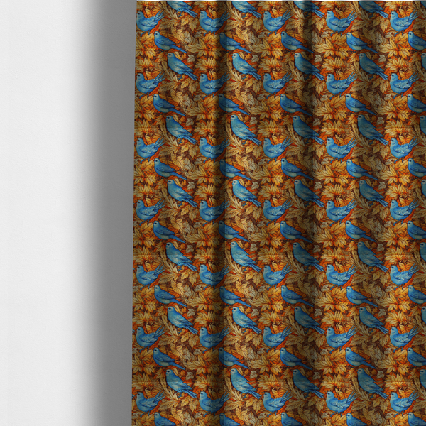 The fabric used to create these made-to-measure curtains is an orange and brown fabric patterned with hand-drawn botanical illustrations of blue birds perched amongst fall leaves featuring an organic style.   

