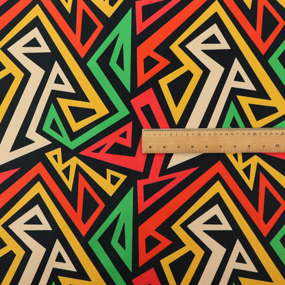 A repeating geometric fabric pattern on a black background featuring interlocking angular lines in red, yellow, green, and beige.