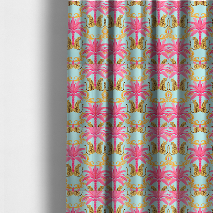 The fabric used to create these made-to-measure curtains is a vibrant fabric pattern featuring repeating pairs of leopards, bright pink palm trees, and gold baroque scrollwork against a light blue background.