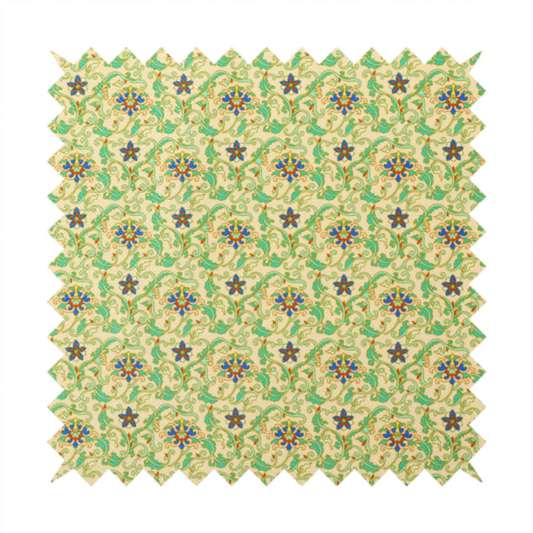 A dense, intricate fabric pattern featuring repeating blue and orange floral blossoms interwoven with teal scrollwork and leafy vines on a light gold background.