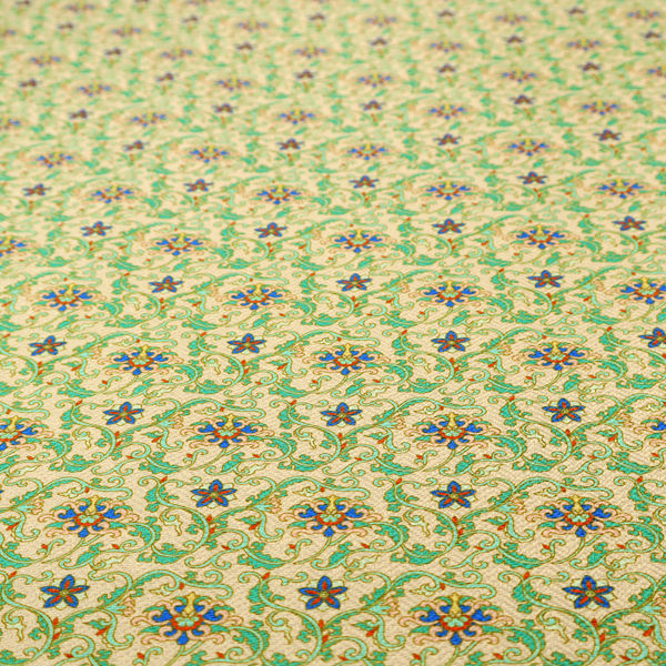 A dense, intricate fabric pattern featuring repeating blue and orange floral blossoms interwoven with teal scrollwork and leafy vines on a light gold background.