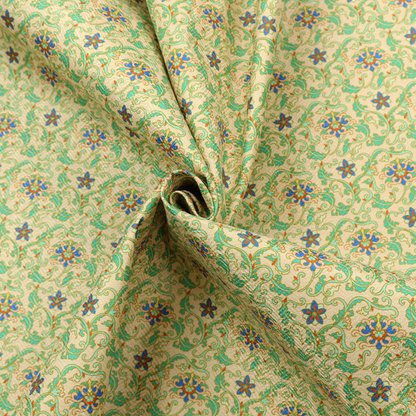 A dense, intricate fabric pattern featuring repeating blue and orange floral blossoms interwoven with teal scrollwork and leafy vines on a light gold background.
