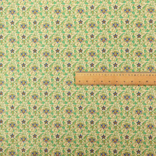 A dense, intricate fabric pattern featuring repeating blue and orange floral blossoms interwoven with teal scrollwork and leafy vines on a light gold background.