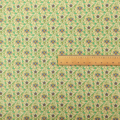 A dense, intricate fabric pattern featuring repeating blue and orange floral blossoms interwoven with teal scrollwork and leafy vines on a light gold background.
