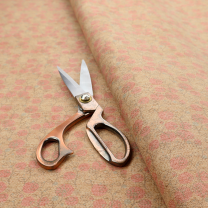A beige fabric patterned with hand-drawn botanical illustrations of small pink flowers and vines featuring an organic style.