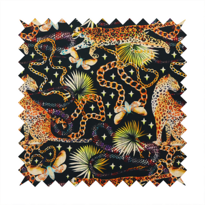 A dark blue fabric patterned with hand-drawn jungle illustrations of leopards, golden chains, tropical leaves, and butterflies featuring an organic style.   