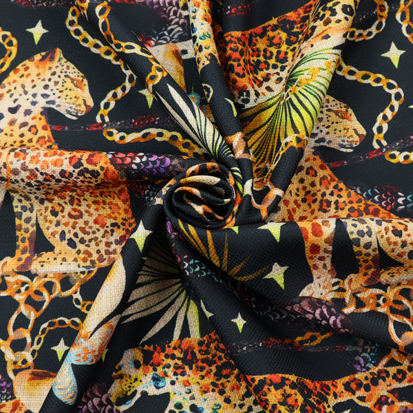 A dark blue fabric patterned with hand-drawn jungle illustrations of leopards, golden chains, tropical leaves, and butterflies featuring an organic style.   
