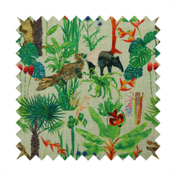 A green and beige fabric patterned with hand-drawn jungle illustrations of alligators, a tapir, tropical trees, and vibrant flowers featuring an organic style.