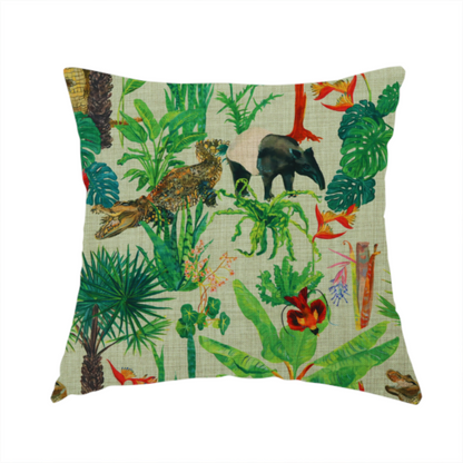The fabric used to create this handmade cushion is a green and beige fabric patterned with hand-drawn jungle illustrations of alligators, a tapir, tropical trees, and vibrant flowers featuring an organic style.