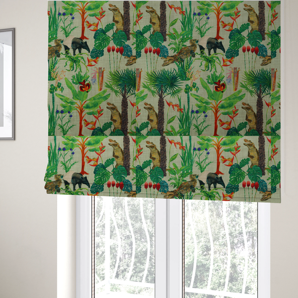 The fabric used to create these Roman blinds is a green and beige fabric patterned with hand-drawn jungle illustrations of alligators, a tapir, tropical trees, and vibrant flowers featuring an organic style.