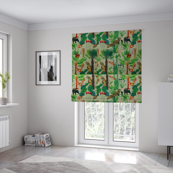 The fabric used to create these Roman blinds is a green and beige fabric patterned with hand-drawn jungle illustrations of alligators, a tapir, tropical trees, and vibrant flowers featuring an organic style.