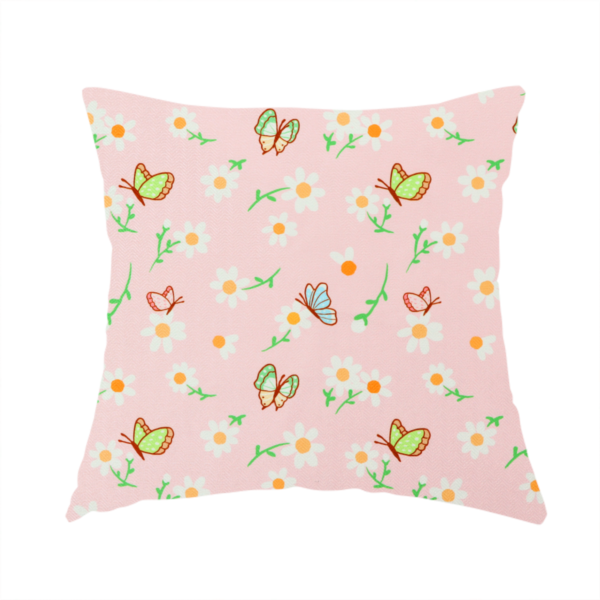 The fabric used to create this handmade cushion is a pink fabric featuring a charming spring pattern with white daisies, green stems, and colourful butterflies in blue, green, and orange scattered across the surface.   