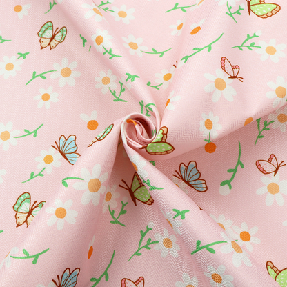 Pink fabric featuring a charming spring pattern with white daisies, green stems, and colourful butterflies in blue, green, and orange scattered across the surface.   