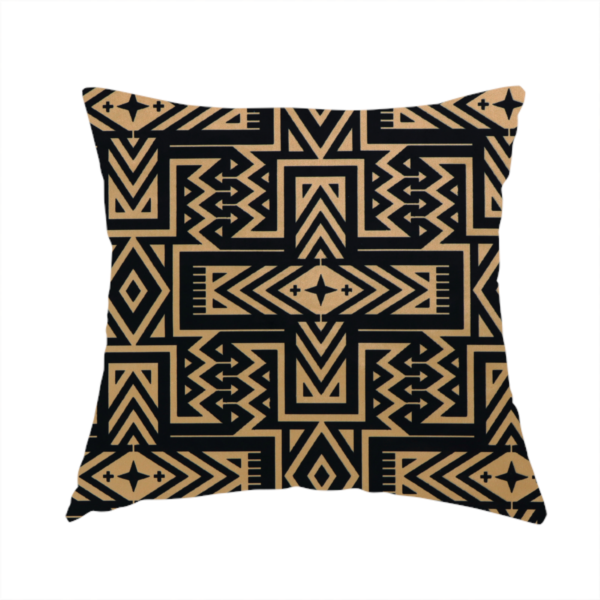 The fabric used to create this handmade cushion is a black and gold geometric fabric featuring an intricate Navajo-inspired tribal pattern with chevron lines, diamonds, and cross motifs.